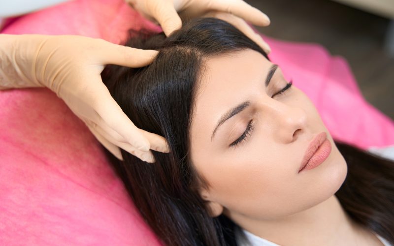 Head massage with hands after mesotherapy in medicine center